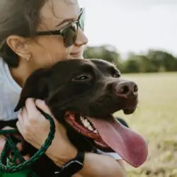 woman in sunglasses with a sweet looking dog -best places for pictures with your dog in Missoula